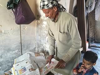 Akhtar Ali alias Dharam Singh goes through newspaper reports about his son’s case.