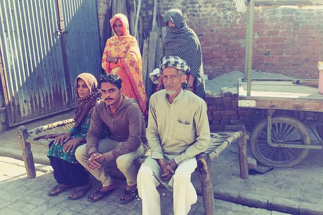Akhtar Ali (right) with his family in Badarkha village on 14 March. On his left is his son Irshad (Kavi). The woman on the left is Ali’s wife.