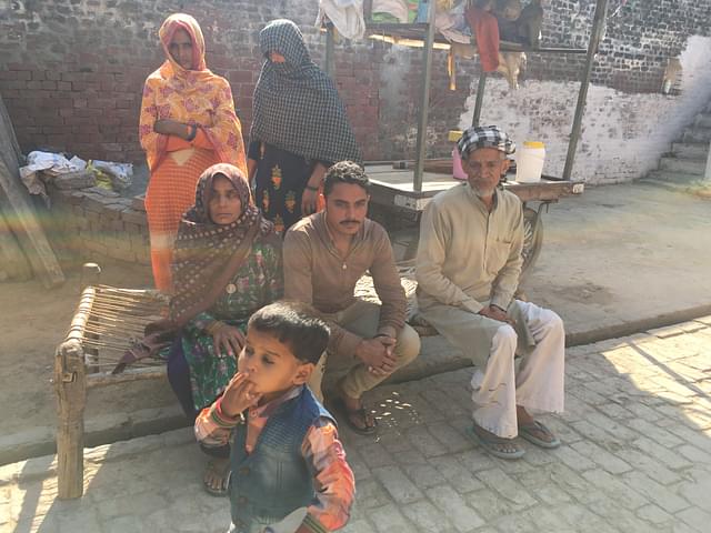 Akhtar Ali (right) with his family in Badarkha village on 14 March. On his left is his son Irshad (Kavi). The woman on the left is Ali’s wife.