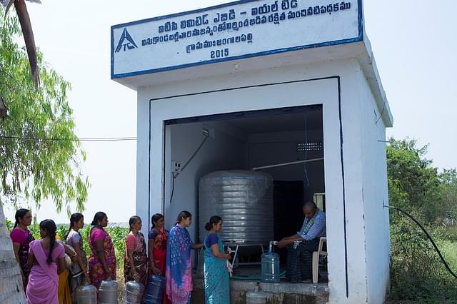 Women queue up before a reverse osmosis (RO) water plant at Jangalapalli village in Guntur district