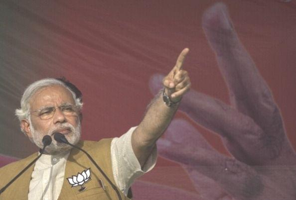Prime Minister Narendra Modi gestures while speaking to the crowd at a rally in Sidhuali, near Lucknow, India. (Kevin Frayer/Getty Images)