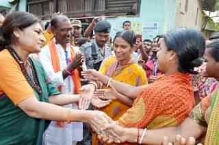 Birbhum BJP candidate Dudh Kumar Mondal (in white) and party leader Rupa Ganguly on the campaign trail in Nalhatier Shitolgram.&nbsp;