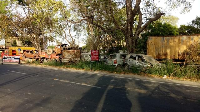 Damaged vehicles piled up across the road from the Chingravati police post. &nbsp;