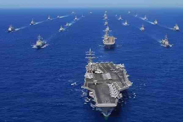 US Navy ships being headed by an aircraft carrier.