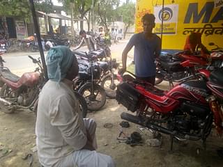 Bikram Pandey at a bike repair shop in Mehnagar market. (Prakhar Gupta/Swarajya)
