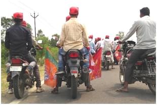 Workers of the NISHAD party ahead of a bike rally with party flags in Gorakhpur’s Campirganj Vidhan Sabha. (Prkahar Gupta/Swarajya) 