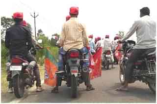 Workers of the NISHAD party ahead of a bike rally with party flags in Gorakhpur’s Campirganj Vidhan Sabha. (Prkahar Gupta/Swarajya)&nbsp;