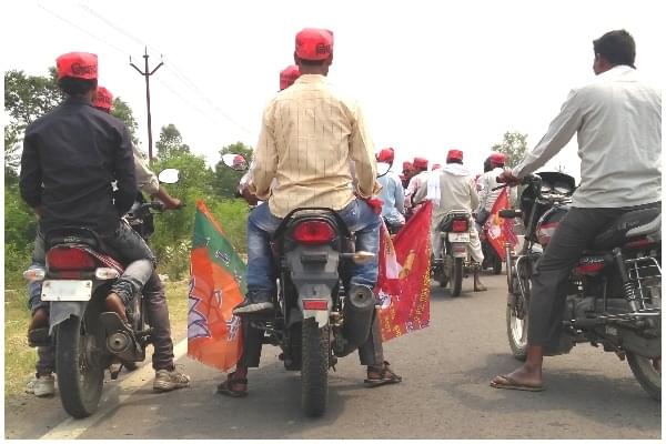 Workers of the NISHAD party ahead of a bike rally with party flags in Gorakhpur’s Campirganj Vidhan Sabha. (Prkahar Gupta/Swarajya) 