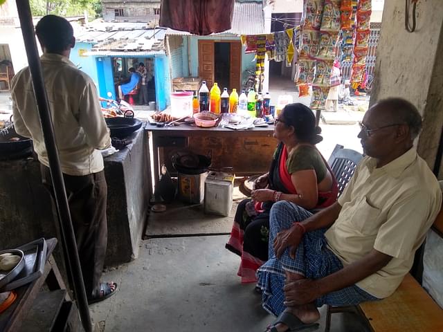 Vikram Vishwakarma and Gita Devi at the latter’s shop. The former’s shop, on the other side of the road, is visible in the background. (Prakhar Gupta/Swarajya )