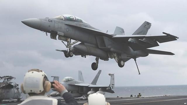 A U.S. Navy’s F/A-18 Super Hornet 
fighter approaches USS 
Carl Vinson. 