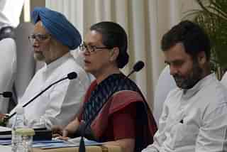 Sonia Gandhi speaks as former Indian Prime Minister Manmohan Singh and Congress Party President Rahul Gandhi look on during a meeting at party headquarters in New Delhi. (Photo credit should read PRAKASH SINGH/AFP/Getty Images)