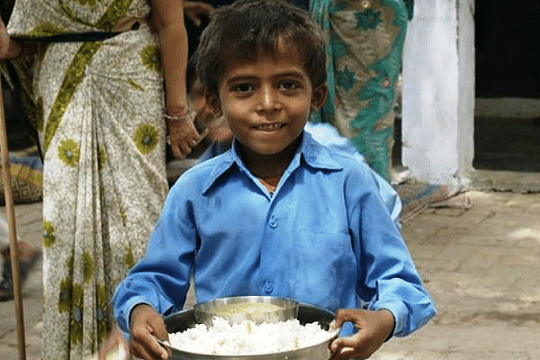 Child holding an Akshaya Patra mid-day meal.