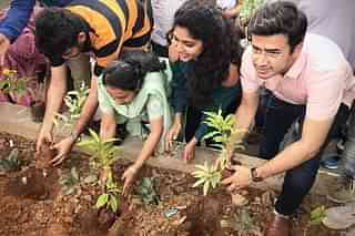 Tejaswi Surya planting a sapling