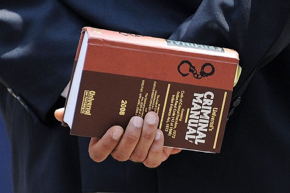 A lawyer holds a criminal manual (INDRANIL MUKHERJEE/AFP/Getty Images).