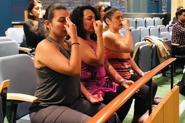 Invitees performing Pranayama