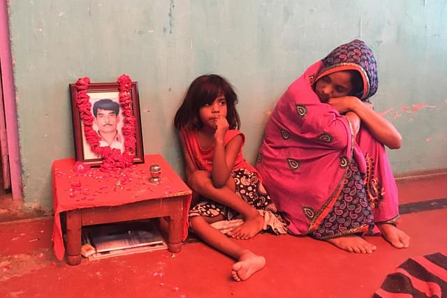 The wife of Bharat Yadav, who was killed by a mob, with their minor daughter at their home in Chowk Bazaar, Mathura. (Picture: Swati Goel Sharma)