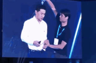 Baidu’s CEO is drenched with water on stage. (via Twitter) 