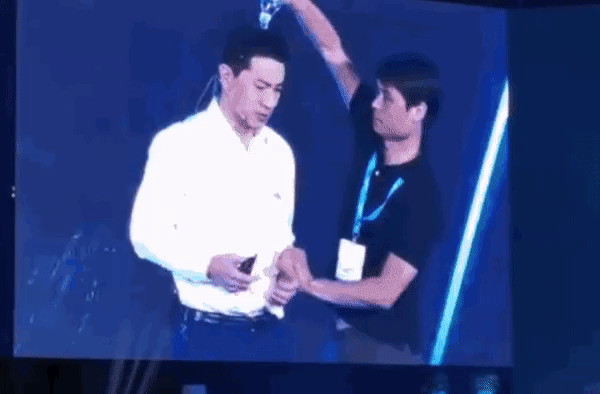 Baidu’s CEO is drenched with water on stage. (via Twitter) 