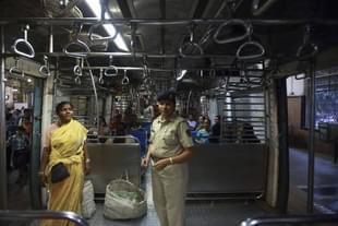 A policewoman checking an all-woman's coach for transgressions by males.