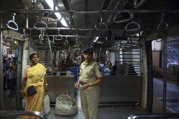 A policewoman checking an all-woman's coach for transgressions by males.