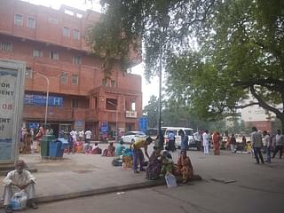 People wait to be attended to outside another government hospital in Delhi.&nbsp;