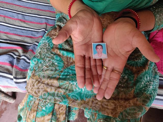 Kiranbala holds the photo of her late husband, Inderpal Bishnoi.