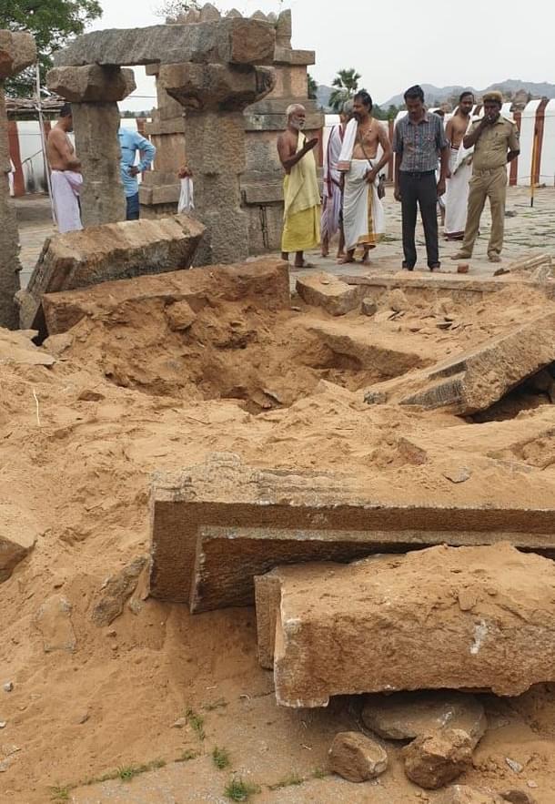 Devotees seen discussing restoration strategy amid the ruins.
