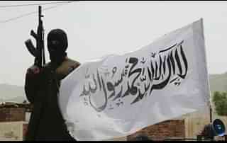 A Taliban fighter with the group’s flag (via Twitter)