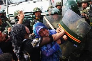 Uighur women clashing with Chinese police during a protest (Representative Image) (@ShimonLevit/Twitter)
