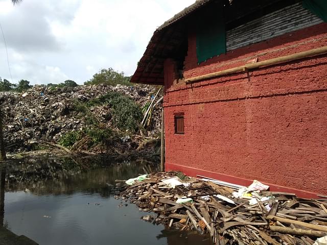 Trash and storm water surrounding  Mandara Keshav Bhat’s house.