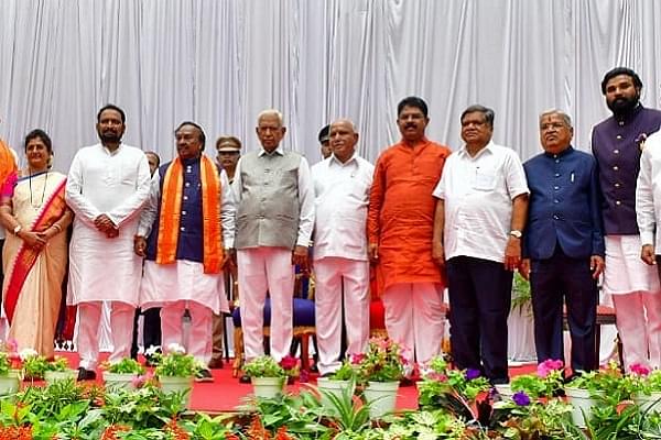 B S Yediyurappa and Karnataka Governor Vajubhai Vala with the newly sworn Ministers