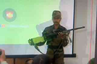 Indian Army soldier displaying the Pakistani sniper rifle which has been recovered.