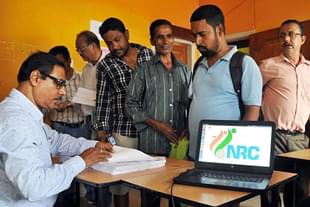 People check their names on the final draft list of Assam’s NRC list in Guwahati.  (Rajib Jyoti Sarma/Hindustan Times via GettyImages) 