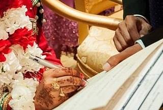 Bride signs marriage documents (representative image)