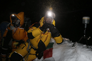 Nepali surveyor Khim Lal Gautam (right) at the summit of Mount Everest in the early hours of 22 May. On his left is a satellite navigation device to measure the mountain’s peak.&nbsp;