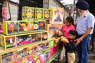 Children buy firecrackers ahead of Diwali festival at a market in New Amritsar. (Sameer Sehgal/Hindustan Times via GettyImages) 