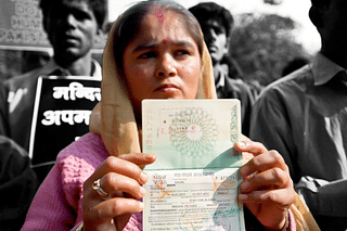 A Hindu refugee from Pakistan shows her now-expired Indian visa page on her passport during a demonstration. (PRAKASH SINGH/AFP/Getty Images)