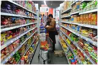 A family shops at a supermarket. (INDRANIL MUKHERJEE/AFP/GettyImages) &nbsp;