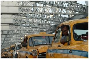 Kolkata taxi drivers in their out-dated cars on Howrah Bridge in Kolkata (DIBYANGSHU SARKAR/AFP/Getty Images)