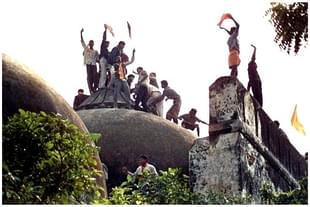 Hindu youth atop the disputed structure in Ayodhya.