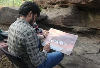 A modern-day artist capturing his ancient counterpart’s work at Bhimbetka.