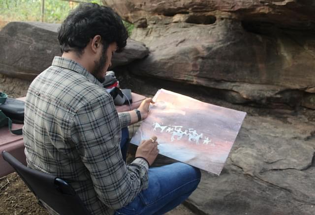 A modern-day artist capturing his ancient counterpart’s work at Bhimbetka.