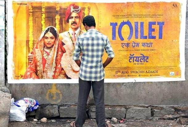An Indian man urinates on a wall on the roadside in front of a poster for the Hindi film ‘Toilet: Ek Prem Katha’, which is inspired by the true-life tale of one man’s battle to build toilets in his village in rural India. / AFP PHOTO / NOAH SEELAM (Photo: NOAH SEELAM/AFP/Getty Images) 