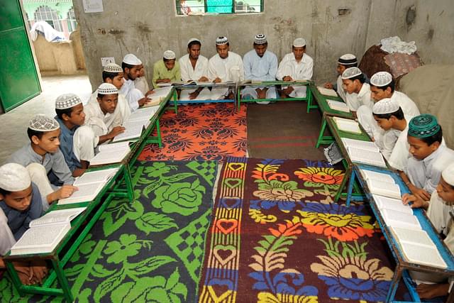 Muslim children reciting verses from Islam’s holy book Quran at a Madrassa (School)  in Noida. (Photo by Burhaan Kinu/Hindustan Times via Getty Images)
