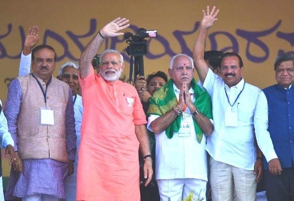 Prime Minister Narendra Modi with Karnataka state BJP president and chief ministerial candidate for upcoming state assembly election, B S Yeddyurappa, Union minister Ananth Kumar, and Sadanand Gowda in Davangere. (Arijit Sen/Hindustan Times via Getty Images)