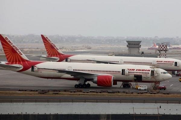 Air India aircraft are seen parked on the tarmac of the international airport in Mumbai. (Sattish Bate/Hindustan Times via Getty Images)