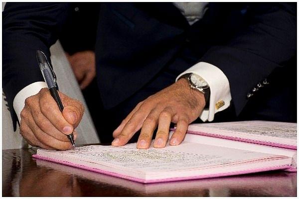 A man signing a record. (Representative Image)
