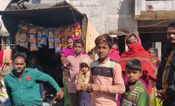 Saddam Qureshi, left, with other men and women from a block adjacent to Dhan Prasad’s block. (Swati Goel Sharma/Swarajya Magazine)