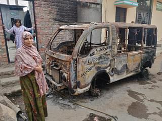 Asmana Jabeen shows her husband’s burnt vehicle.&nbsp;