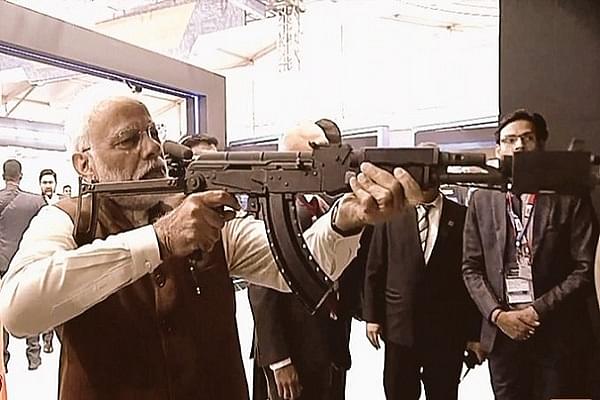 Prime Minister Narendra Modi checking out the virtual firing range at DefExpo 2020 (@livefist/Twitter)